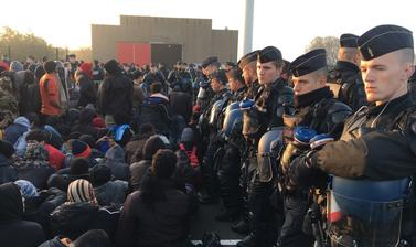 Migrants waiting to enter the hangar at Calais.