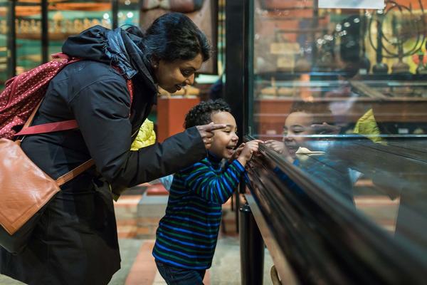 Adult and child looking into display case